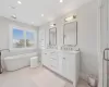 Bathroom with a tub to relax in and vanity