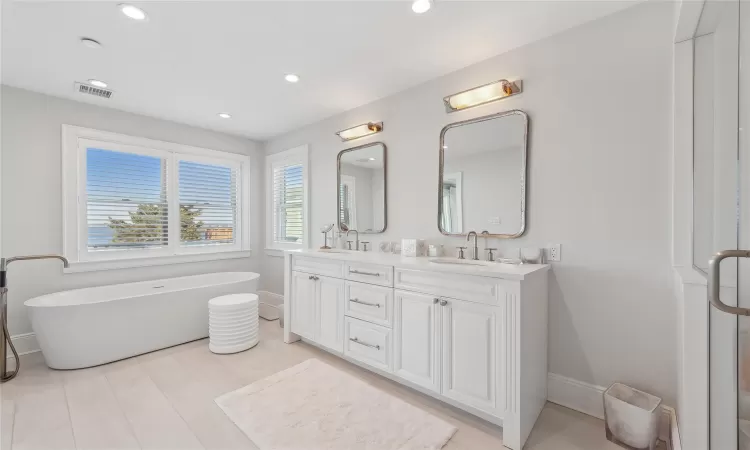 Bathroom with a tub to relax in and vanity