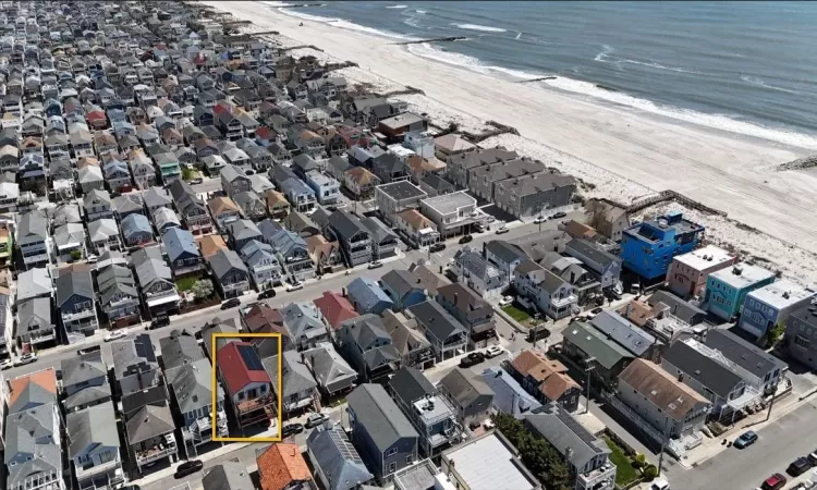 Bird's eye view with a water view and a beach view