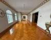 Hall with ornamental molding and light parquet flooring