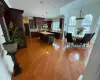 Kitchen with hardwood / wood-style floors, a center island, dark brown cabinets, sink, and pendant lighting