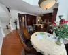 Dining room with ornamental molding and dark wood-type flooring