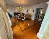 Dining room featuring hardwood / wood-style floors, decorative columns, and a notable chandelier