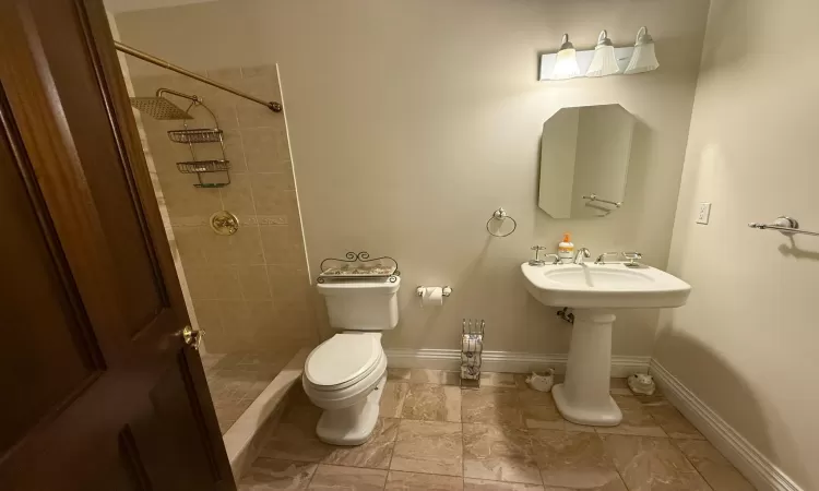 Bathroom with toilet and tiled shower