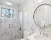 Full bathroom featuring vanity, tile walls, a marble finish shower, toilet, and backsplash