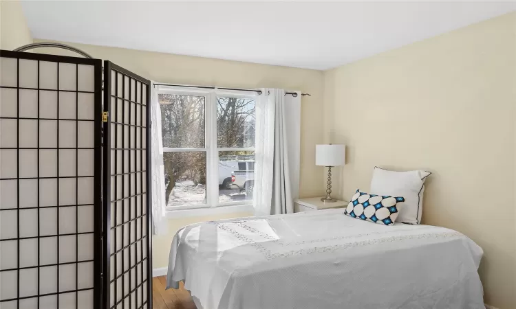 Bedroom featuring baseboards and wood finished floors