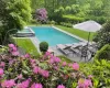 Outdoor pool featuring a patio area and a yard