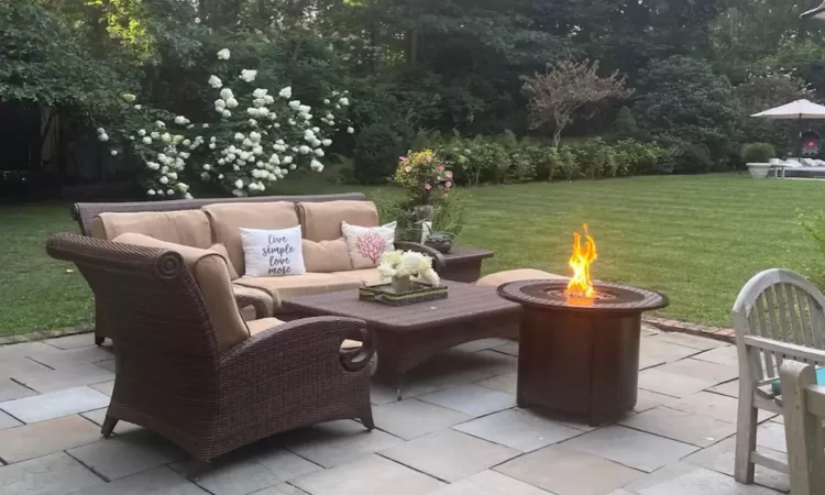 View of patio featuring an outdoor living space with a fire pit