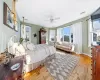 Bedroom featuring light wood-style floors, visible vents, baseboards, and a ceiling fan