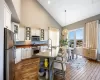 Kitchen featuring stainless steel appliances, glass insert cabinets, hanging light fixtures, and open shelves