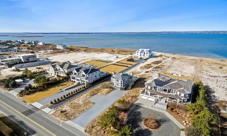 Birds eye view of property with a water view and a residential view