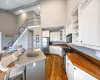 Kitchen featuring dark wood finished floors, white cabinets, glass insert cabinets, appliances with stainless steel finishes, and a sink