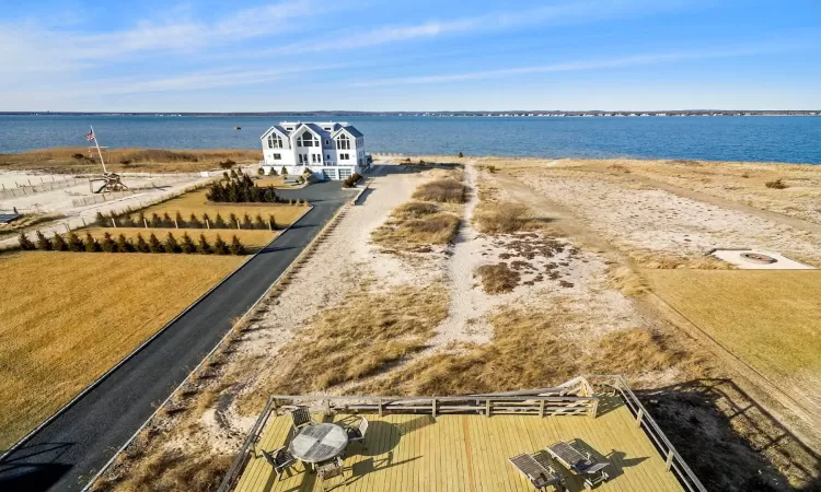 Birds eye view of property with a water view