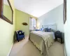 Bedroom featuring light carpet and baseboards