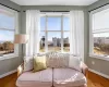 Living area with plenty of natural light, wood finished floors, and baseboards