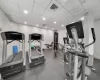 Workout area featuring recessed lighting, visible vents, and a drop ceiling