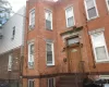 View of exterior entry featuring brick siding and cooling unit