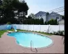 View of swimming pool with a fenced in pool, a fenced backyard, a water slide, a patio area, and a diving board