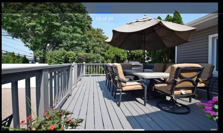 Wooden terrace featuring outdoor dining area