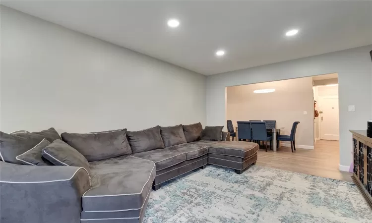 Living room featuring recessed lighting, baseboards, and wood finished floors