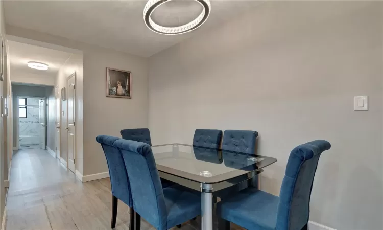 Dining room featuring light wood-type flooring and baseboards