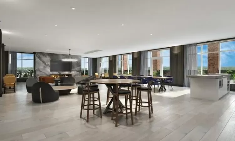 Dining room featuring light hardwood / wood-style flooring, a wall of windows, and a healthy amount of sunlight