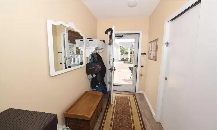 Entryway featuring baseboards and wood finished floors