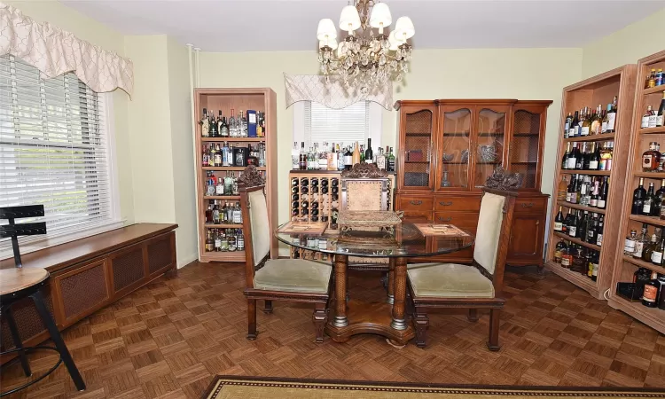 Dining area featuring a bar and a notable chandelier