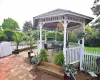 View of patio / terrace with a grill, a gazebo, fence, outdoor dining area, and a wooden deck