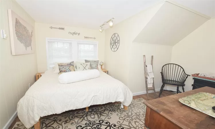 Bedroom with baseboards and wood finished floors