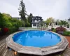 View of swimming pool featuring a fenced in pool, fence, and a wooden deck