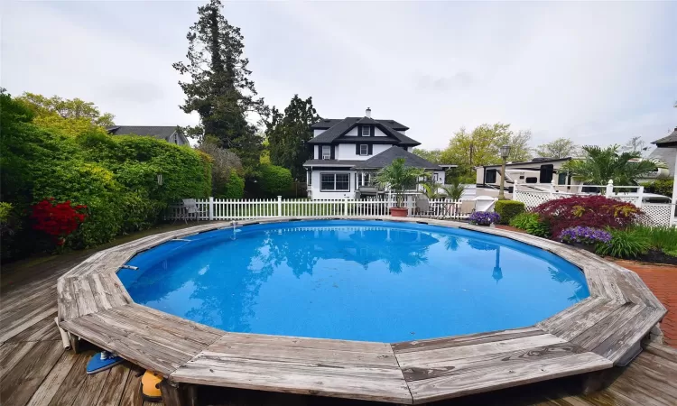 View of swimming pool featuring a fenced in pool, fence, and a wooden deck