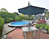 View of pool with outdoor dining space, fence, a wooden deck, and a fenced in pool