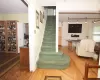 Stairway with parquet flooring, visible vents, and baseboards