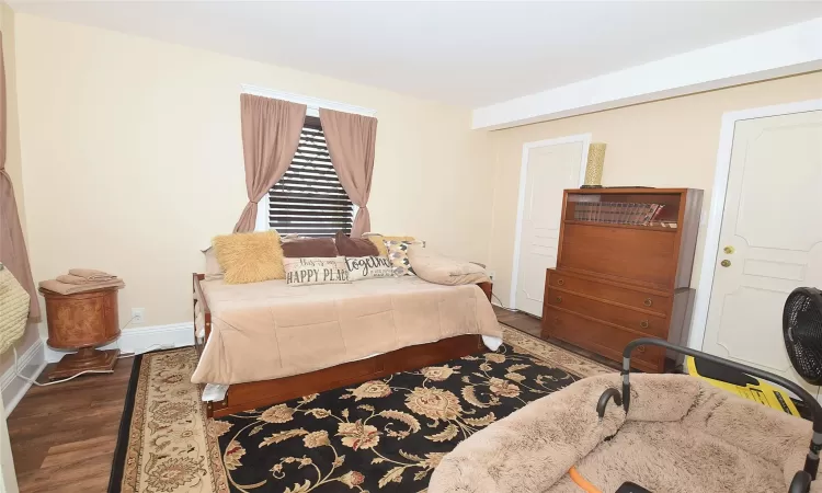 Bedroom with baseboards and wood finished floors