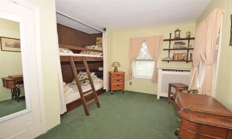 Bedroom featuring dark colored carpet