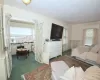 Bedroom with dark colored carpet and multiple windows