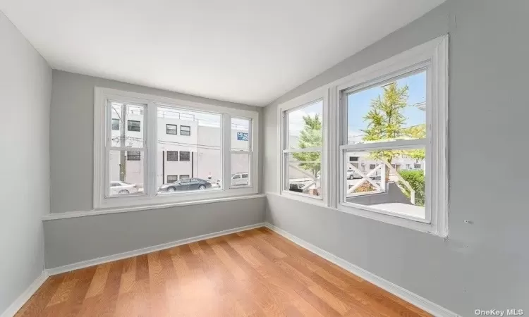 Spare room with light wood-type flooring and baseboards