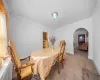 Carpeted dining space with ornamental molding