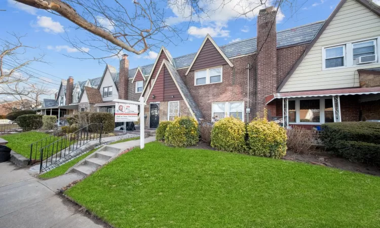 Tudor-style house featuring a front yard