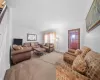 Carpeted living room featuring crown molding