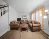 Living room with carpet flooring and ornamental molding