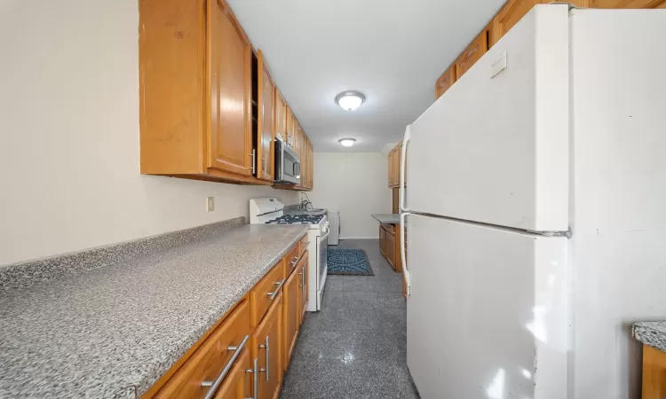 Kitchen featuring white appliances