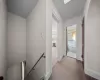 Hallway with radiator, a skylight, and carpet flooring