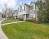 View of property featuring a front lawn