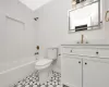 Full bathroom with tile patterned flooring, vanity, toilet, and bathtub / shower combination