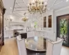 Dining space featuring a chandelier, recessed lighting, light wood-type flooring, and crown molding