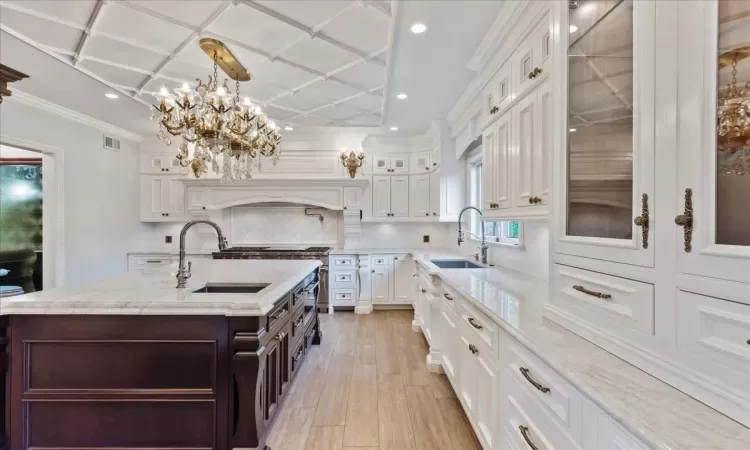 Kitchen featuring white cabinets, a sink, and decorative backsplash