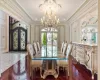 Dining space featuring french doors, ornamental molding, and a notable chandelier