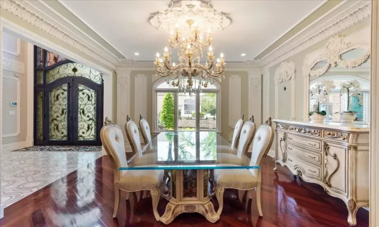 Dining space featuring french doors, ornamental molding, and a notable chandelier